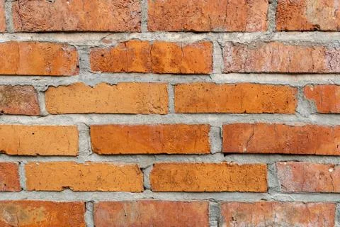 Wall of red ceramic bricks, background close up Stock Photos