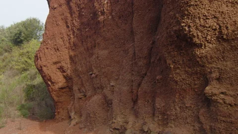A wall of red clay rock in the middle of nature, in Spain Stock Footage 223935719