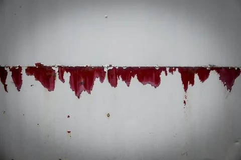 A wall with red paint dripping down it Stock Photos