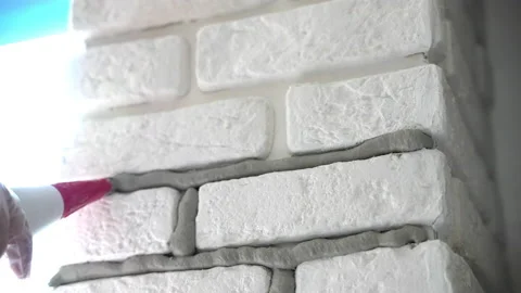 Wall renovation on construction site, process of filling joints with mortar for 스톡 동영상 209151369