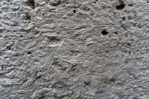A wall with a rough texture and a few holes Stock Photos