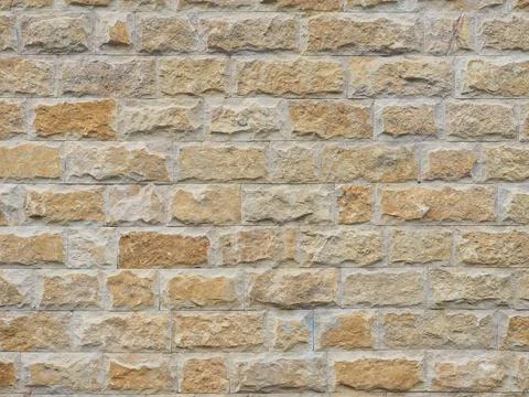 Wall with a rough textured cladding of beige red rectangular tiles. Not seamless 写真素材