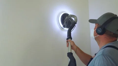 Wall sanding. Close-up, rear view. Construction worker works with modern sanding Stock Footage 319210606
