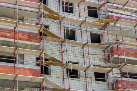 Wall with scaffolding background Stock Photos