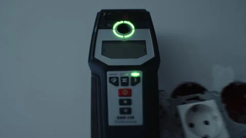 Wall scanner detecting wiring during electrical work 스톡 동영상 312227154