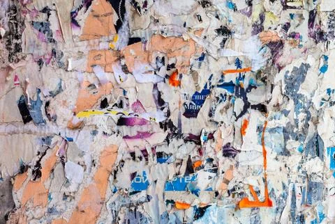 Wall with scraps of old paper as background Stock Photos