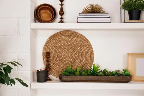 Wall shelves with beautiful decor elements indoors. Interior design Stock Photos