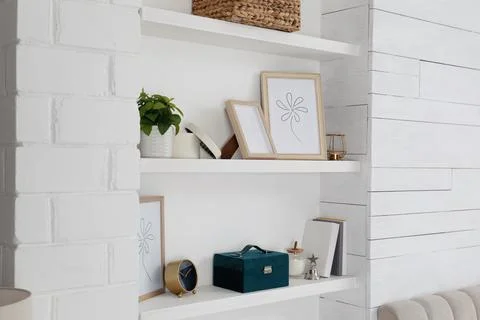 Wall shelves with beautiful decor elements indoors. Interior design Foto stock