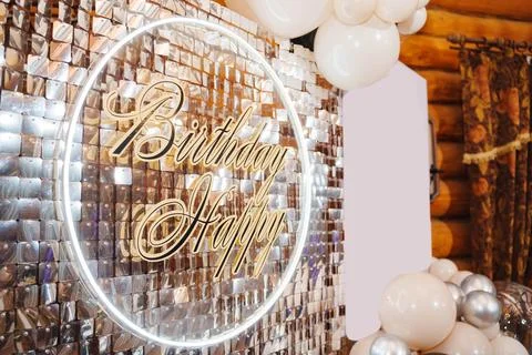 A wall of silver sequins and a circle with the inscription Happy Birthday. Stock Photos