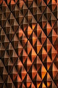 The wall of a skyscraper in the setting sun. Background Stock Photos