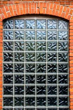 Wall of small bricks with a window Stock Photos