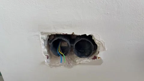 Wall socket hole.Exposed electrical wires. Stock Footage 340427738