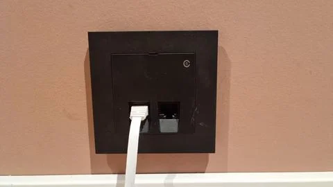 Wall socket with network and power connections mounted in a room setting Foto stock