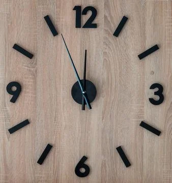 Wall square clock made of wood. Stock Photos