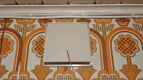 Wall with square panel and floral wallpaper in a home setting during daylig.. Stock Photos