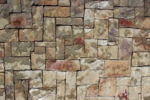 Wall of square stones of different sizes. Rectangular tiles of different sizes Stock Photos