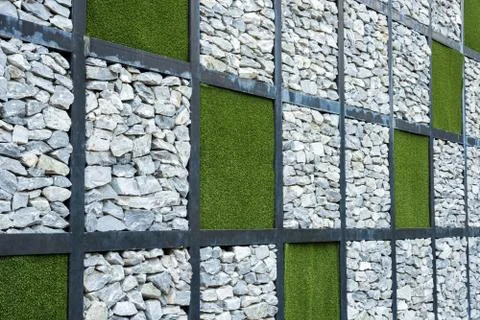 Wall of stone and artificial grass background. Stock Photos