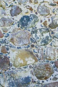 Wall of stone and brick of an old destroyed building Stock Photos