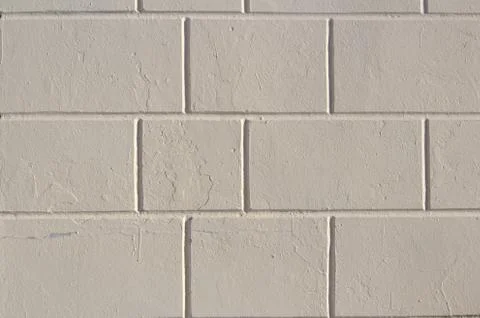 Wall of a stone house from painted concrete blocks close-up Stock Photos