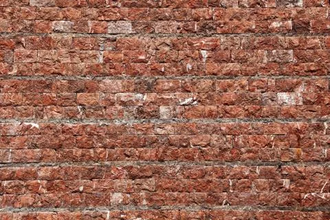 Wall of stone in red tint 写真素材