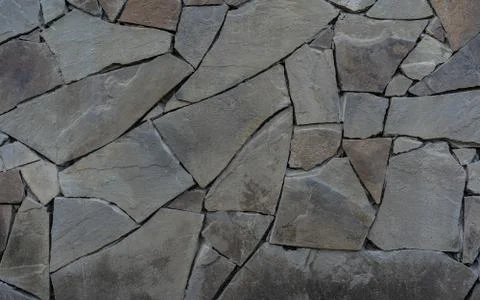 Wall of stone as texture and background Stock Photos