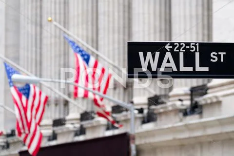 Wall street sign with the New York Stock Exchange on the backgro Stock Photos