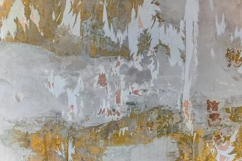 Wall surface with many layers of old plaster, putty and pieces of wallpaper Stock Photos