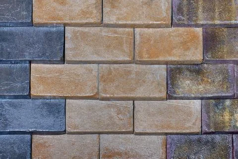Wall surface with rectangular brick blocks with different colors and stone te Stock Photos