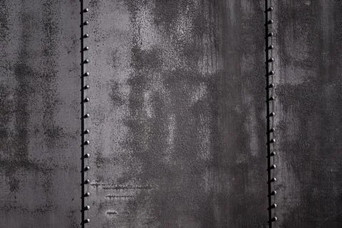 Wall surface shows aged metal. Rusty wall texture feels industrial. Wall Stock Photos