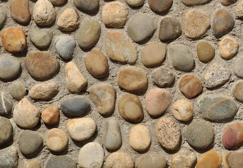 Wall texture built with cement and beach cobbles Foto stock