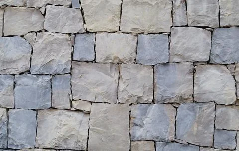 Wall texture built from pieces of white stone Stock Photos
