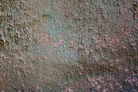 Wall with a texture of cement plaster small protrusions with peeled green p.. Stock Photos