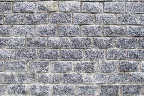 Wall texture of gray granite bricks Stock Photos