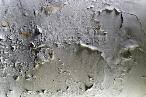 Wall texture with peeling white paint and deep shadows Stock Photos