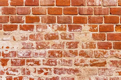 Wall texture from red old damaged bricks. Abstract background. Stock Photos