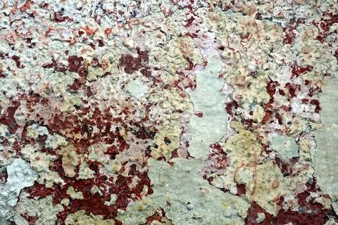Wall textured with peeling light green paint with reddish-rusty spots Stock Photos