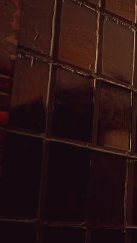 Wall of tiles with rough texture and dark colors in a room Stock Footage 346758950