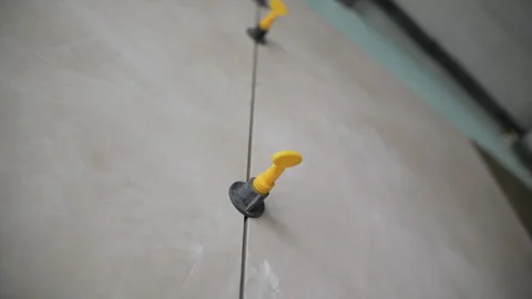 Wall tiles secured with leveling system clips Stock Footage 314058623