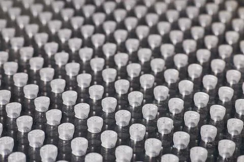 Wall of tiny machine parts to probe in metrology CMM machine for small flaws Stock Photos