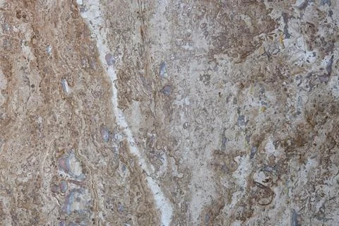 Wall of travertine with stone layers of different colors. Close up architecture Stock Photos