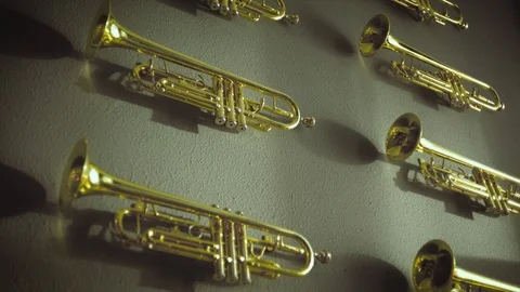 Wall of trumpets instruments with outside light and shadow time lapse Stock Footage 103810972