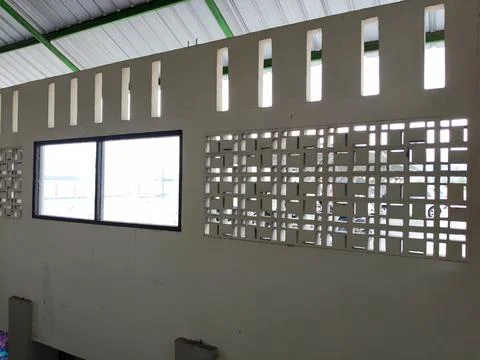 A wall with two large windows and several ventilation holes Fotos de archivo