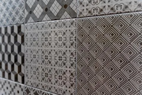 A wall with a variety of tile patterns, including squares, diamonds Stock Photos