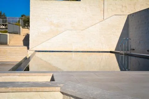 The wall of the villa and the surface of the pool Stock Photos