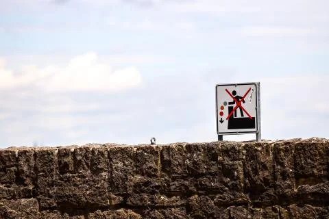 Wall with warning not to fall down Stock Photos