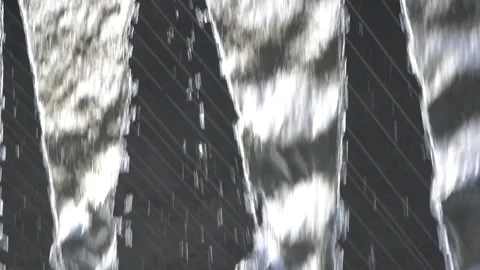 A wall with water coming out of it. The water is flowing in a triangular pattern Stock Footage 276354728