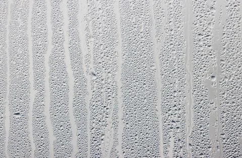 A wall with a white background and a pattern of small white dots Stock Photos
