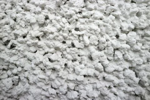 The wall is white not smooth at close range as the background. Stock Photos