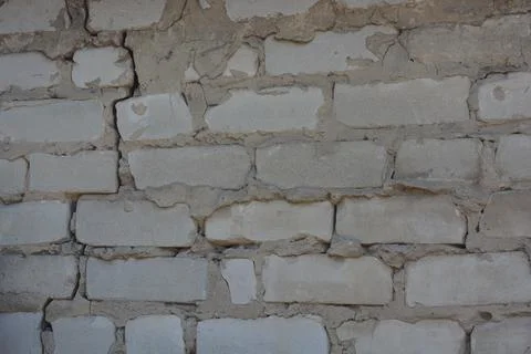 Wall of white smooth brick with gray cement masonry, construction error. 写真素材