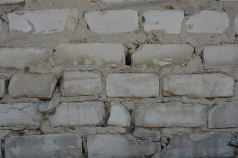 Wall of white smooth brick with gray cement masonry, construction error. 写真素材